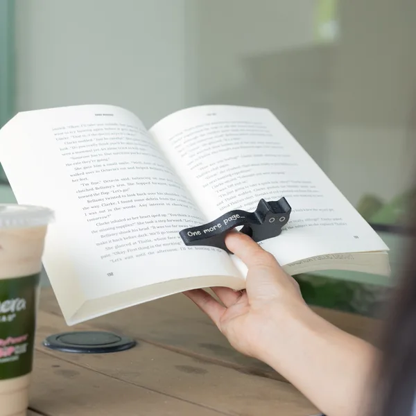 Cat-shaped wooden book page holder.